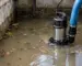 pompă submersibilă apă murdară într-un subsol cu apă tulbure și resturi fine